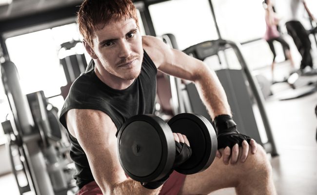 man with weight training equipment on sport gym club