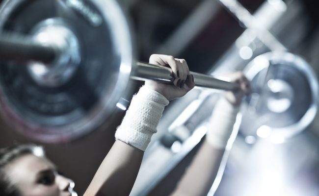 Young woman weight training