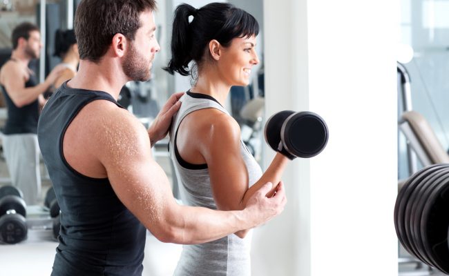 gym woman personal trainer with weight training